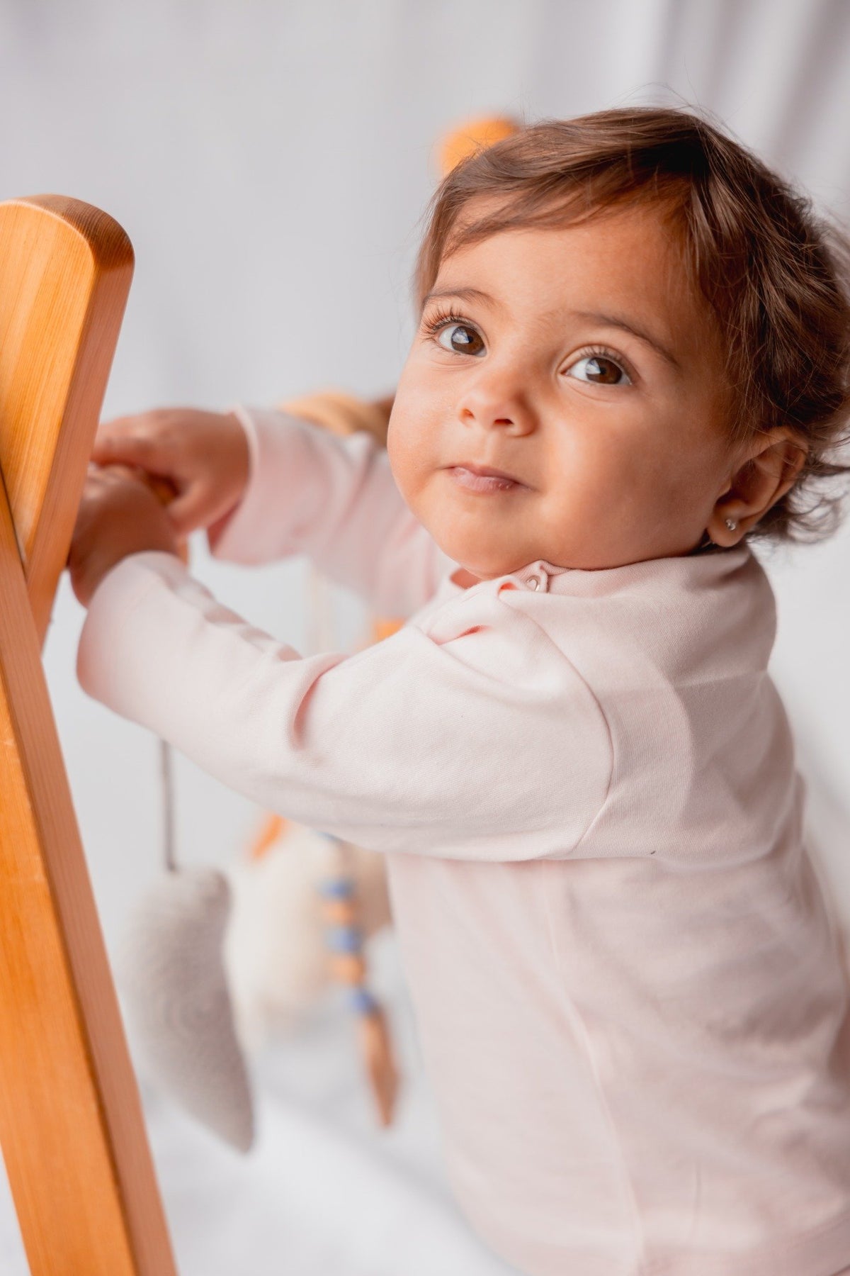Baby sitting in the blush long sleeve pyjama set