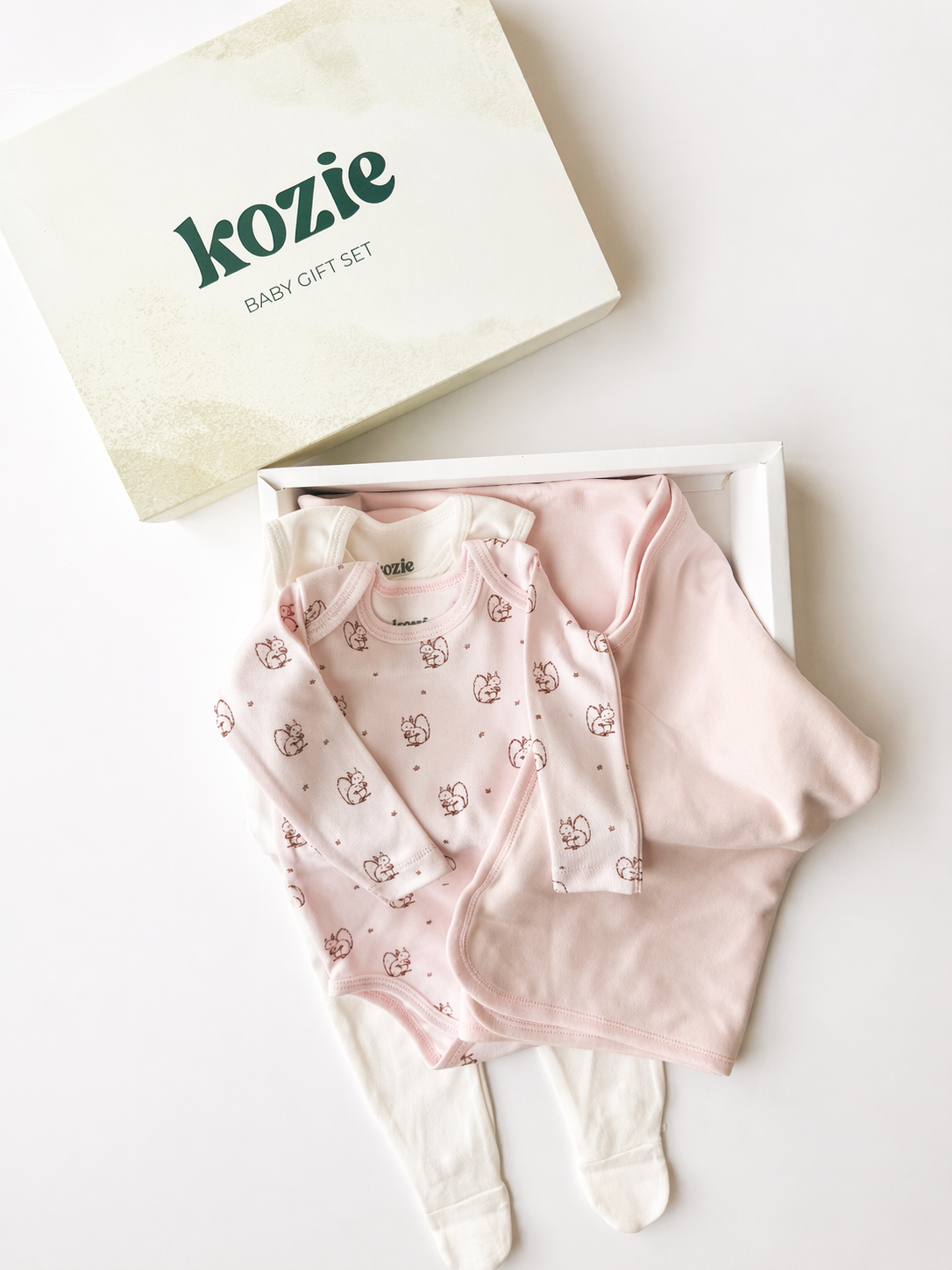 The Romper Gift Box in Forest Squirrel with the blush squirrel-print bodysuit and white romper