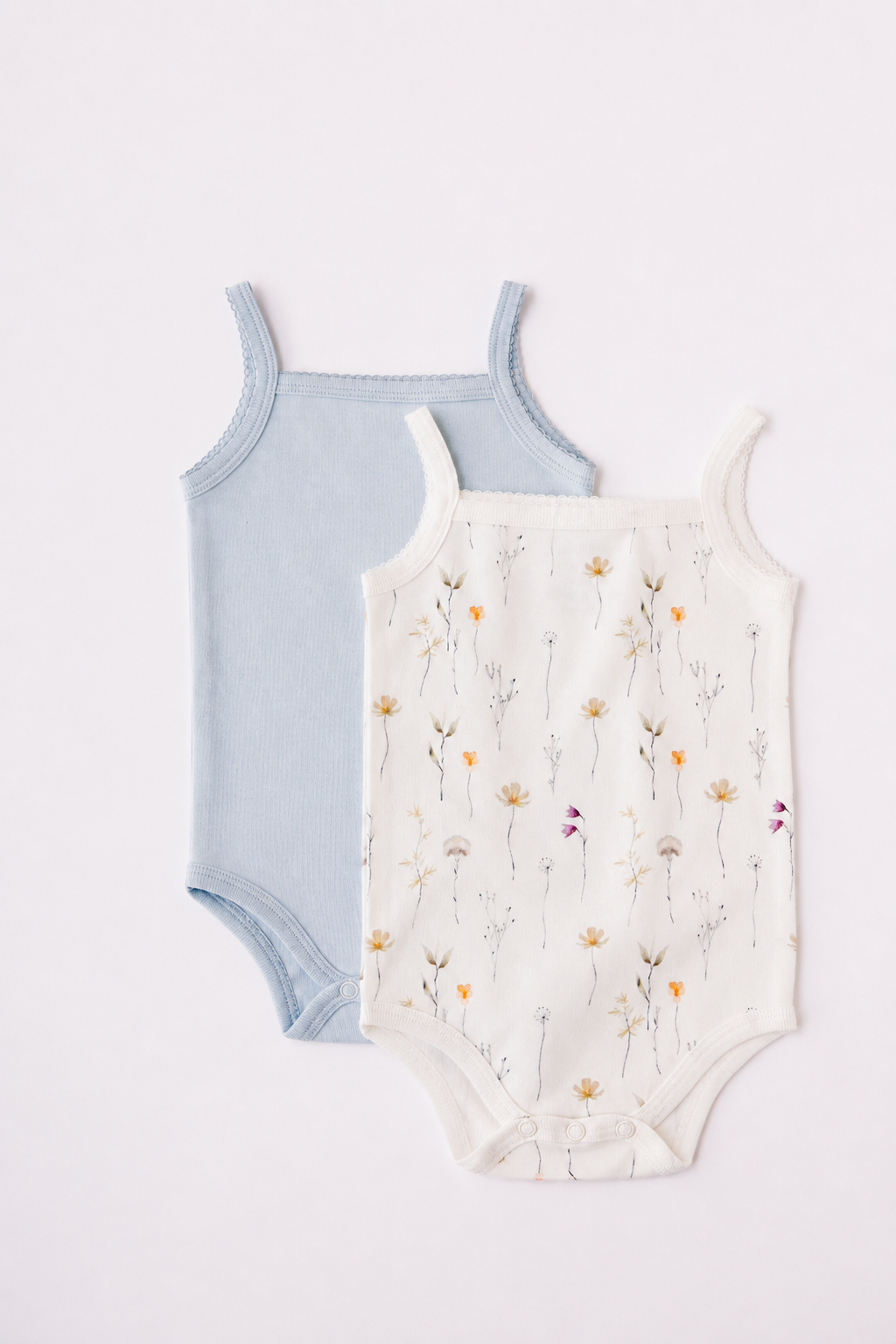 Two sleeveless bodysuits in sky blue and Wild Flowers print