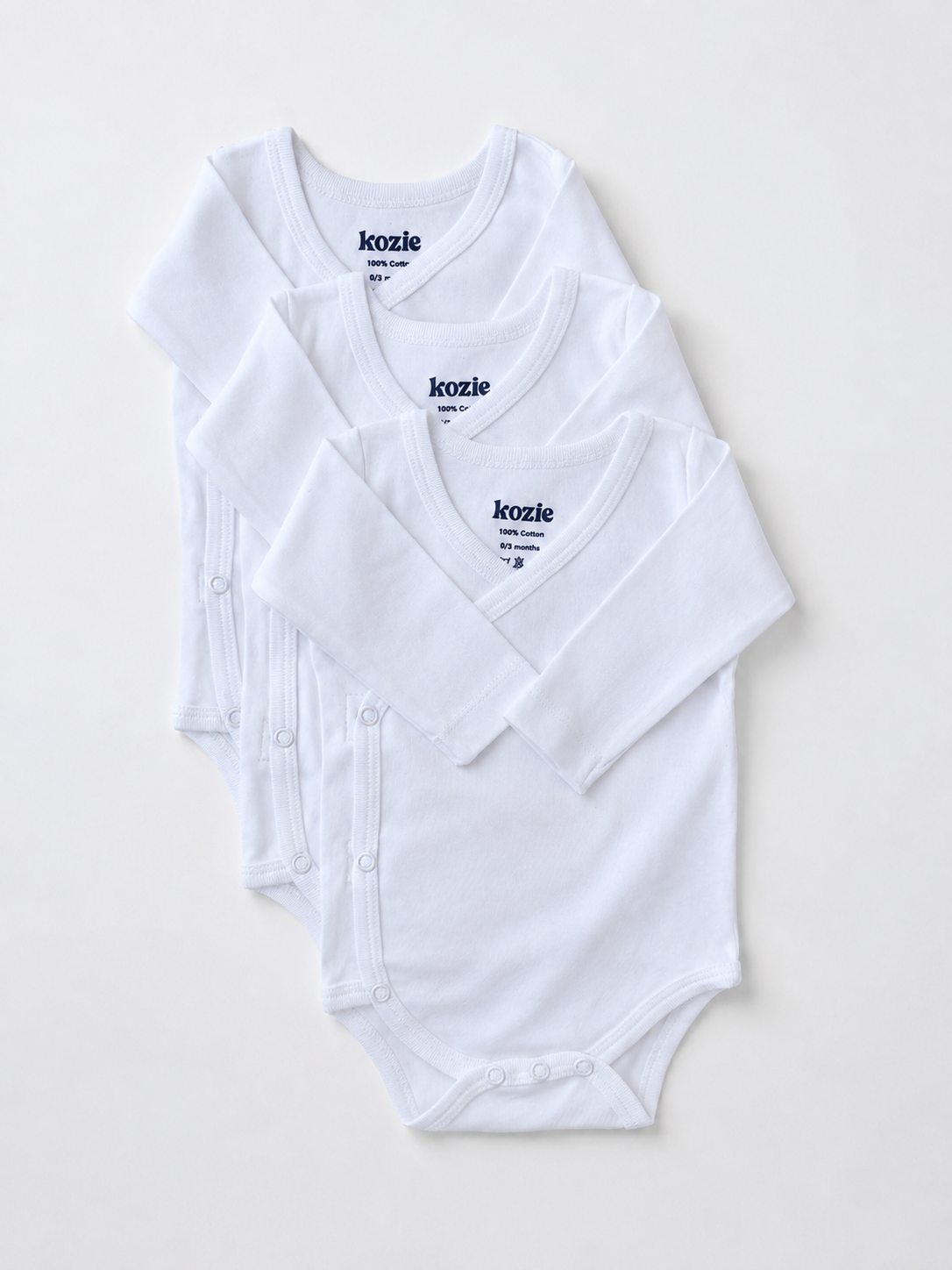 Three white long sleeve kimono bodysuits, laid flat