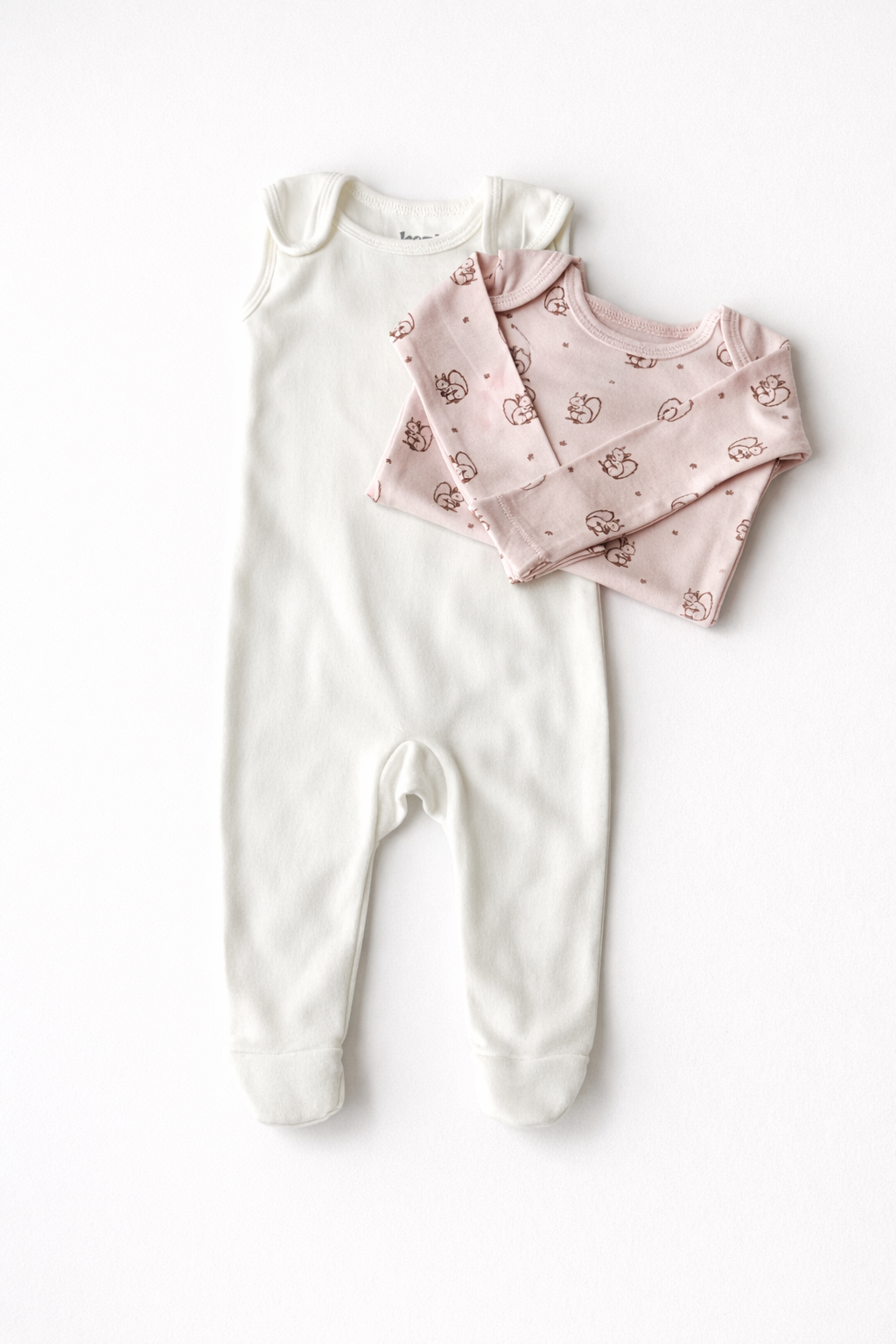 Forest Squirrel footed romper laid flat with its blush printed bodysuit